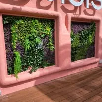 Stand de exposici&oacute;n con moqueta ferial y decoraci&oacute;n verde